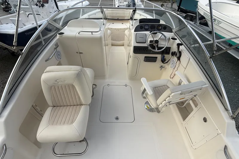 Slide: The Image of 2005 Scout 222 Dorado boat interior with steering wheel and seating. - 3
