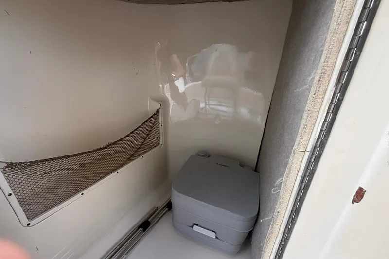 Slide: The Image of Compact cabin interior of 2005 Scout 222 Dorado boat with portable toilet. - 7