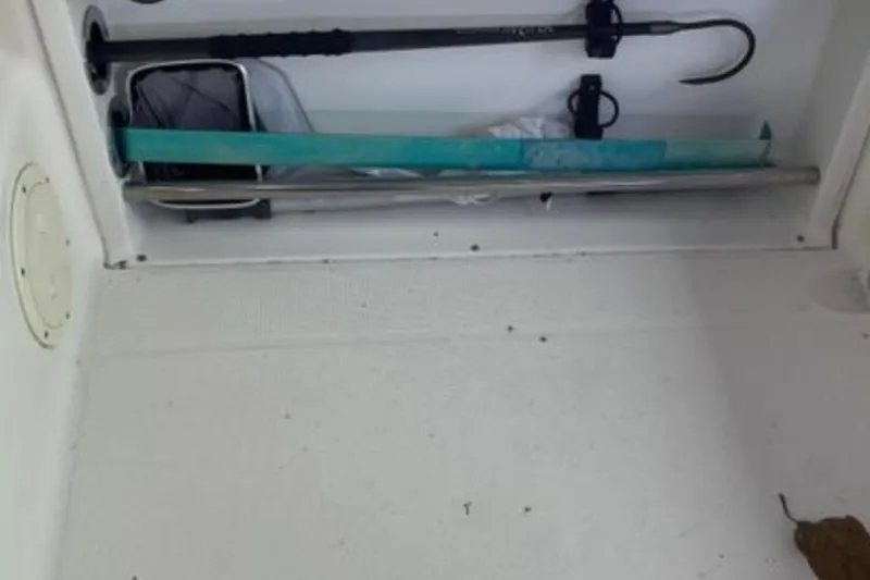Slide: The Image of Storage compartment in a 2017 Robalo R265 Walkaround boat with fishing gear. - 27