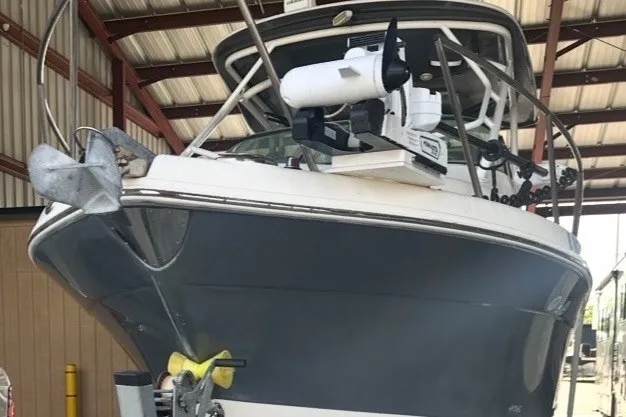 Slide: The Image of 2017 Robalo R265 Walkaround boat in a covered storage facility. - 2