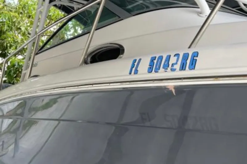 Slide: The Image of 2017 Robalo R265 Walkaround boat with registration FL 5042 RG, docked near greenery. - 15