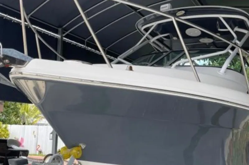 Slide: The Image of 2017 Robalo R265 Walkaround boat with sleek design under a canopy. - 14