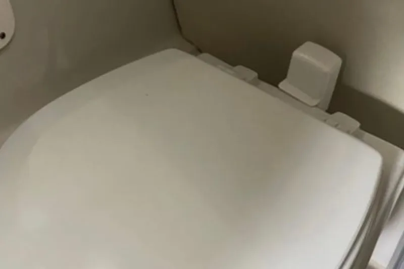 Slide: The Image of 2017 Robalo R265 Walkaround boat toilet seat in cabin interior. - 33