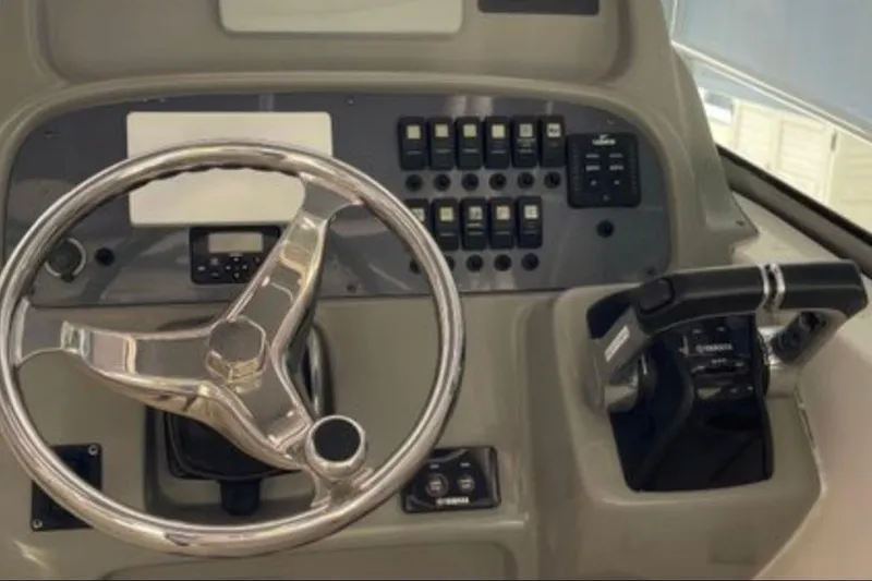 Slide: The Image of Steering console of 2017 Robalo R265 Walkaround boat with controls and switches. - 21