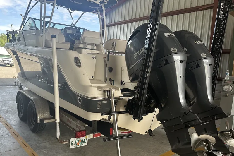 Slide: The Image of 2017 Robalo R265 Walkaround boat with dual Yamaha 200 engines on a trailer. - 3