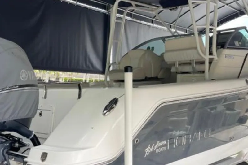 Slide: The Image of 2017 Robalo R265 Walkaround boat under canopy, featuring Yamaha engine cover. - 18