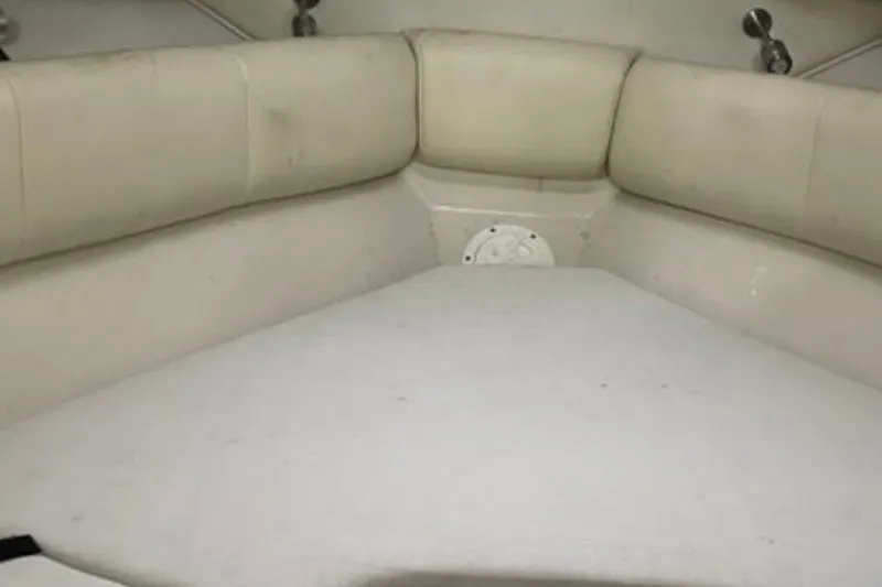 Slide: The Image of 2017 Robalo R265 Walkaround cabin interior with cushioned seating and white upholstery. - 29