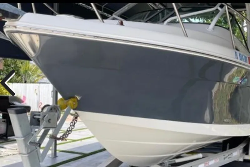 Slide: The Image of 2017 Robalo R265 Walkaround boat on trailer, side view. - 12