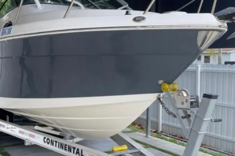 Slide: The Image of 2017 Robalo R265 Walkaround boat on a Continental trailer, parked outdoors. - 13