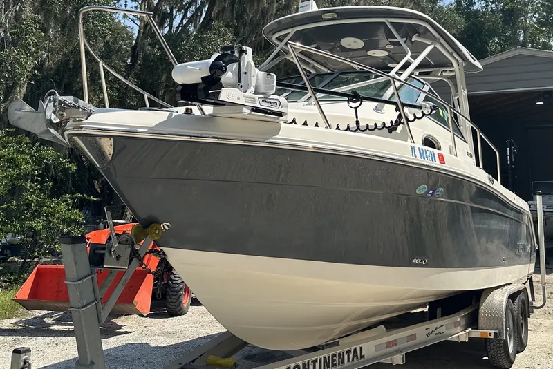 The Image of 2017 Robalo R265 Walkaround boat on trailer, parked outdoors. - 1