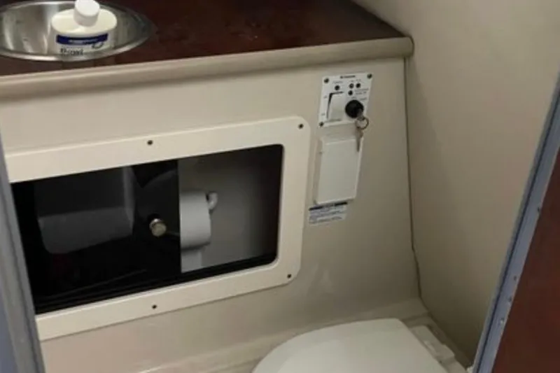Slide: The Image of 2017 Robalo R265 Walkaround boat bathroom with sink and toilet. - 32