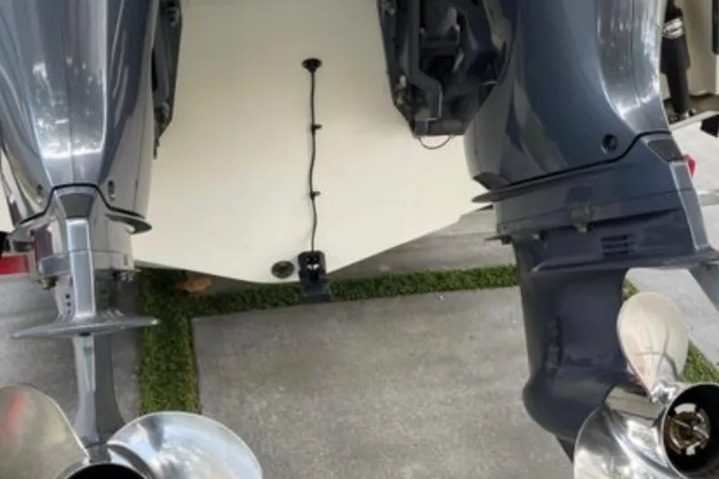 Slide: The Image of 2017 Robalo R265 Walkaround boat with dual outboard motors, viewed from the rear. - 36