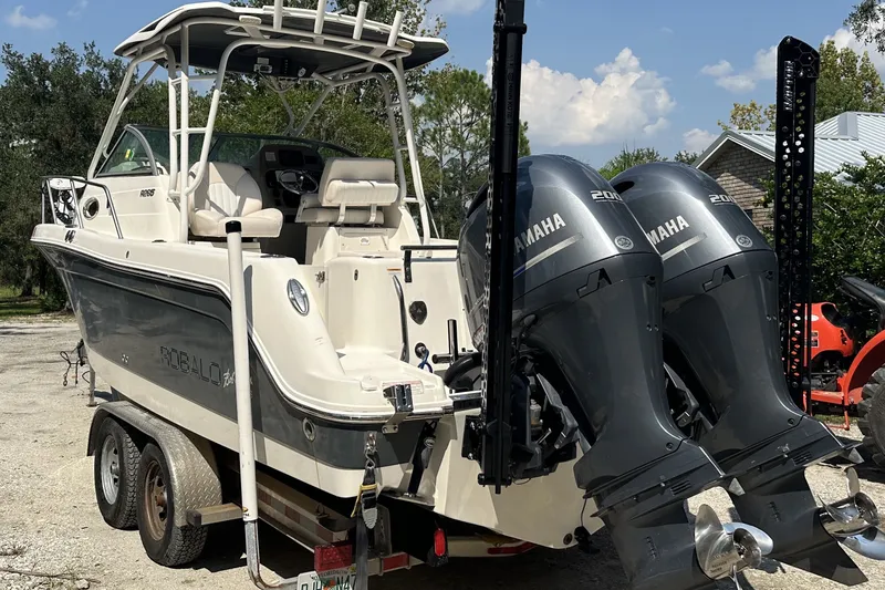 Slide: The Image of 2017 Robalo R265 Walkaround boat with dual Yamaha engines on a trailer. - 5