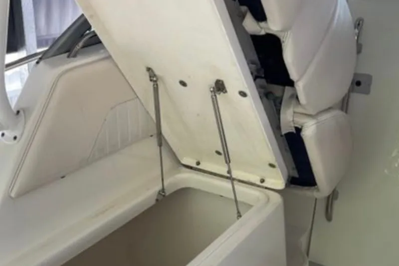 Slide: The Image of 2017 Robalo R265 Walkaround boat seat storage compartment open. - 25