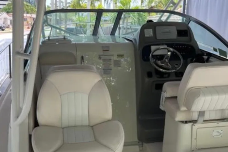 Slide: The Image of 2017 Robalo R265 Walkaround boat interior with steering wheel and seating. - 22