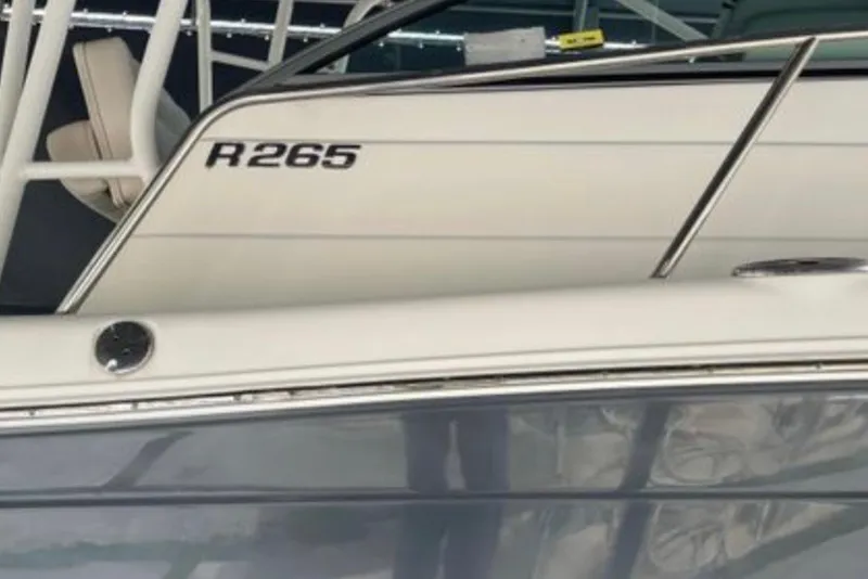 Slide: The Image of 2017 Robalo R265 Walkaround boat, close-up view of the side and railing. - 16