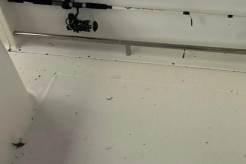 Slide: The Image of 2017 Robalo R265 Walkaround boat interior with fishing rod storage. - 28