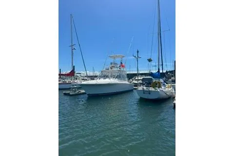 The Image of 2008 Luhrs 28 boat docked in a sunny marina with sailboats. - 0