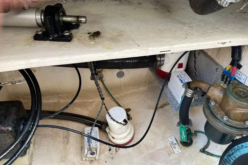 Slide: The Image of 2008 Luhrs 28 Open boat engine compartment with various mechanical components and wiring. - 15