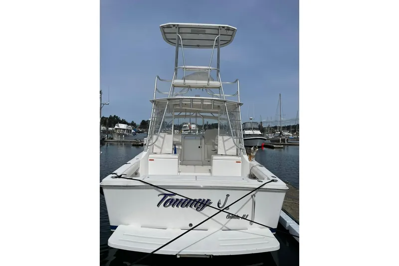 Slide: The Image of 2008 Luhrs 28 Open boat docked at marina, rear view with tower and seating. - 16