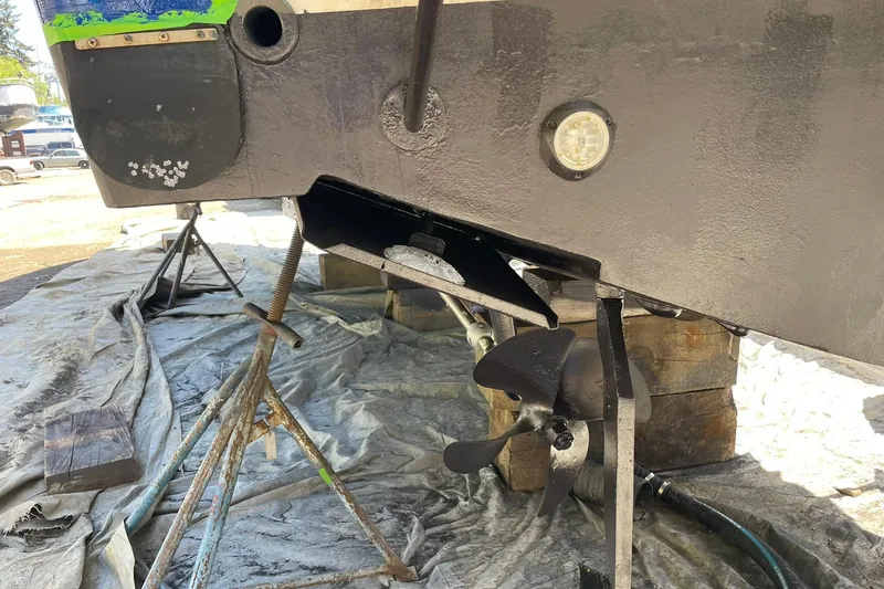 Slide: The Image of 2008 Luhrs 28 Open boat under maintenance, showing propeller and hull details. - 22
