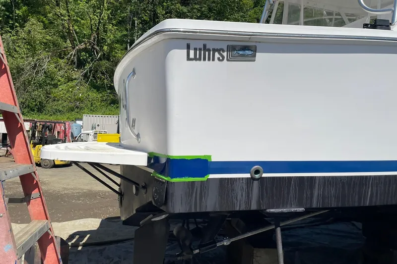 Slide: The Image of 2008 Luhrs 28 Open boat undergoing maintenance with visible ladder and equipment. - 25