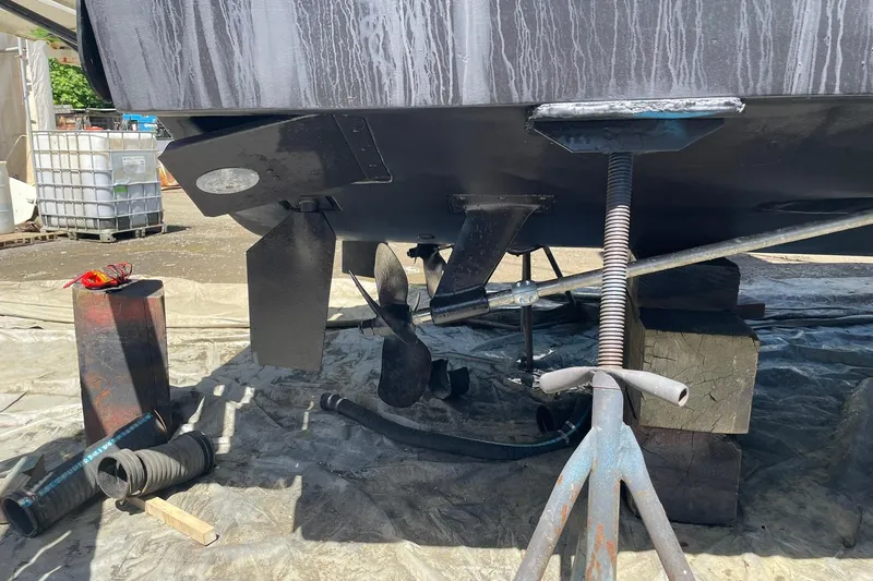 Slide: The Image of 2008 Luhrs 28 Open boat under maintenance, showing propeller and rudder on dry dock. - 27