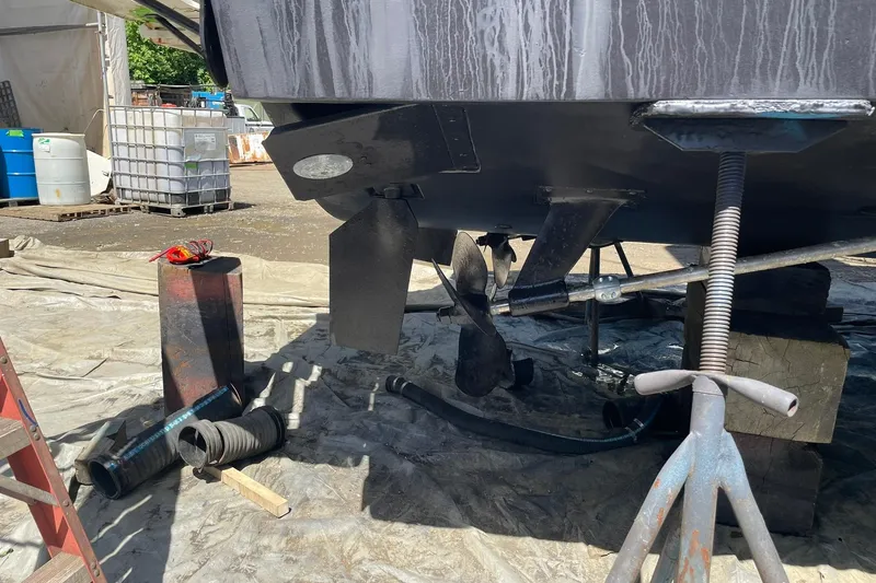 Slide: The Image of 2008 Luhrs 28 Open boat under maintenance, showing propeller and rudder details. - 28