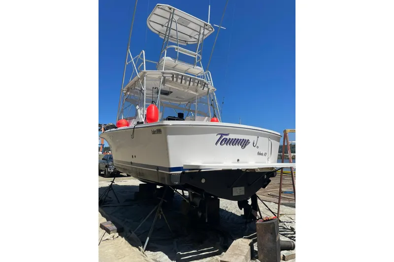 Slide: The Image of 2008 Luhrs 28 Open boat on dry dock, rear view with blue sky background. - 32