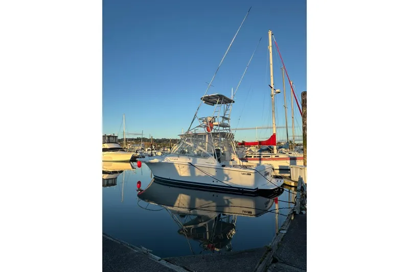 Slide: The Image of 2008 Luhrs 28 Open boat docked at marina, reflecting on calm water. - 35