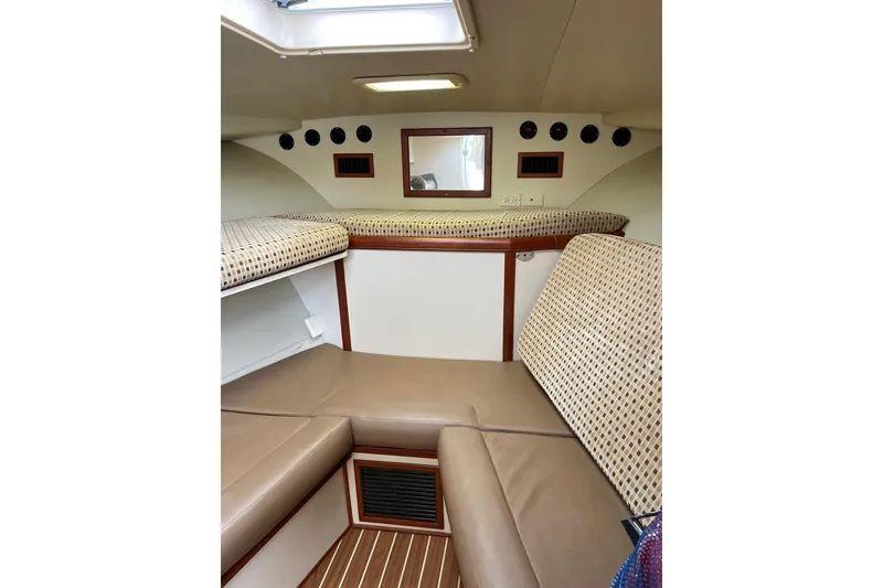 Slide: The Image of Interior cabin of 2008 Luhrs 28 Open boat with cushioned seating and wood accents. - 5