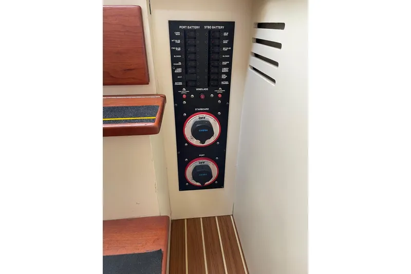 Slide: The Image of Control panel of a 2008 Luhrs 28 Open boat, featuring battery switches and circuit breakers. - 7