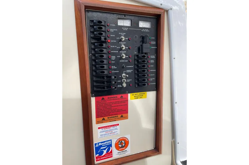 Slide: The Image of Electrical control panel on a 2008 Luhrs 28 Open boat with warning labels. - 8