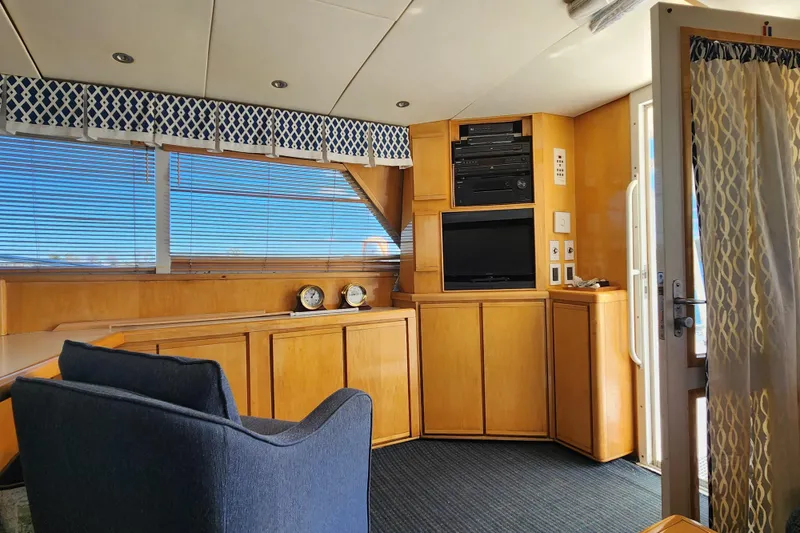 Slide: The Image of Interior of 1995 Bertram 43 Convertible yacht with wooden cabinetry and blue accents. - 10
