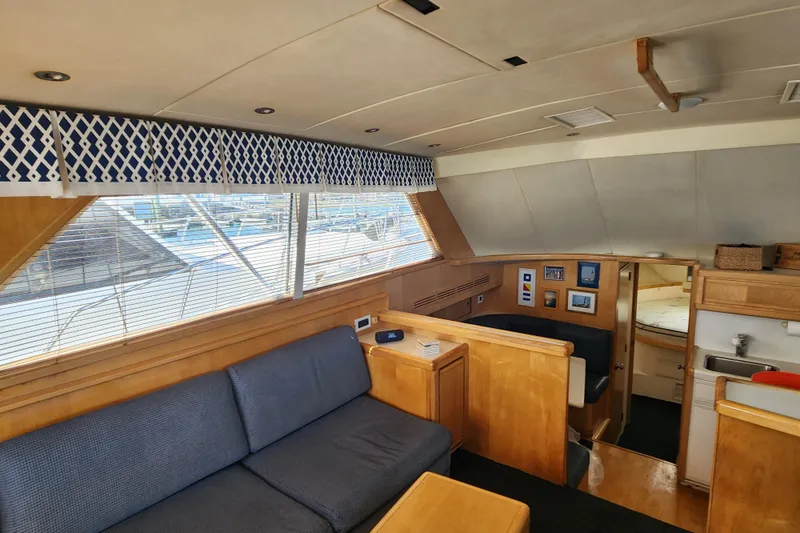 Slide: The Image of Interior of 1995 Bertram 43 Convertible yacht with cozy seating and nautical decor. - 11