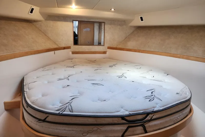 Slide: The Image of Cozy cabin interior of 1995 Bertram 43 Convertible with a comfortable mattress. - 15
