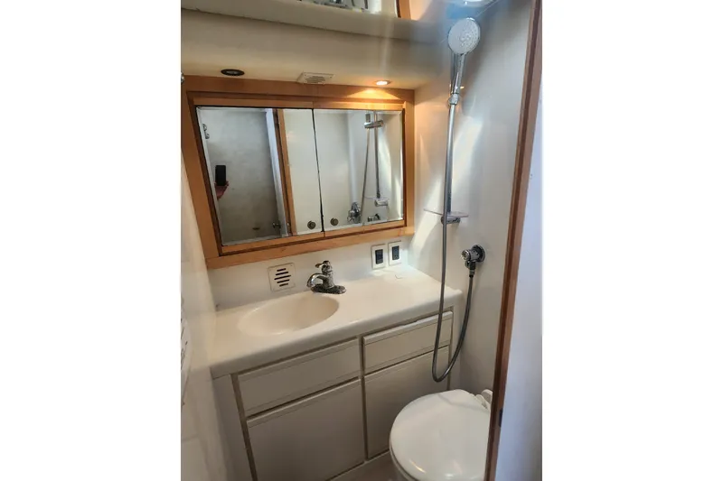 Slide: The Image of Bathroom interior of a 1995 Bertram 43 Convertible yacht, featuring sink and shower. - 16