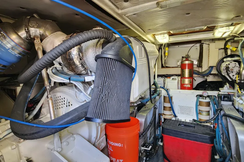 Slide: The Image of Engine room of a 1995 Bertram 43 Convertible boat, featuring mechanical components and equipment. - 17