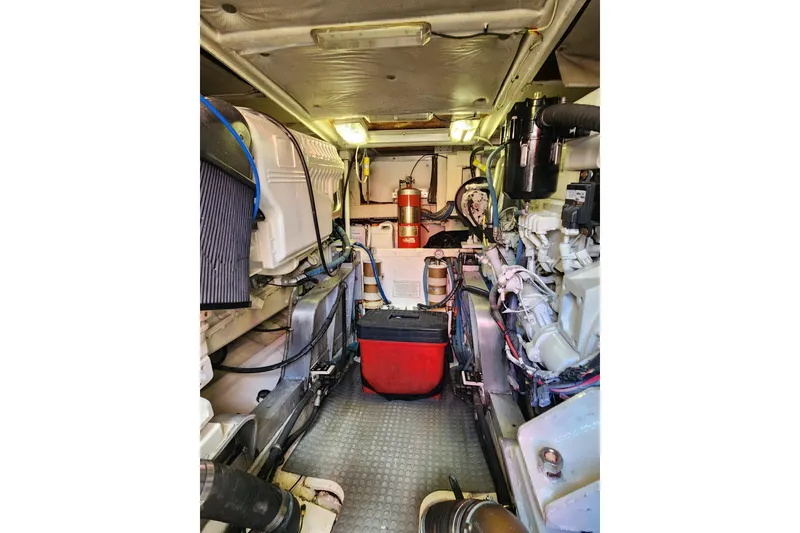 Slide: The Image of Engine room of a 1995 Bertram 43 Convertible yacht, showcasing machinery and equipment. - 18
