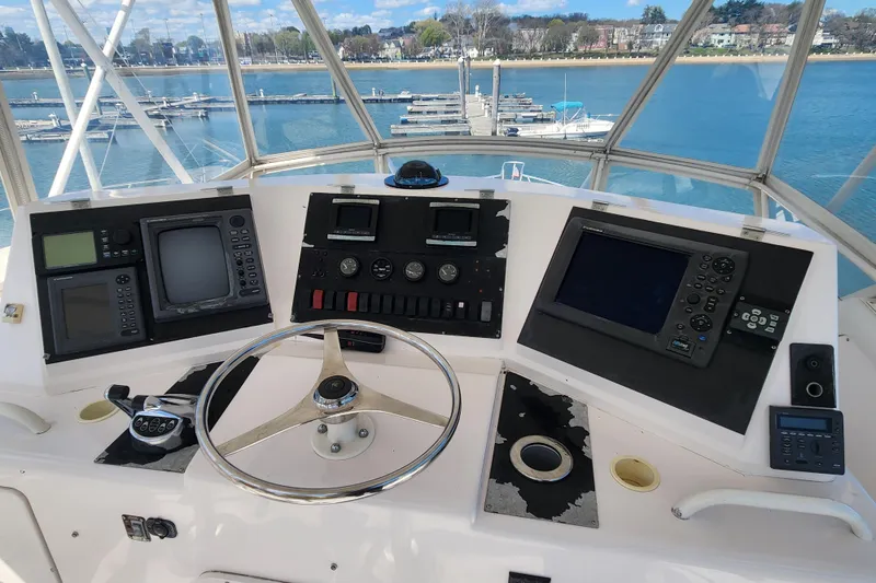 Slide: The Image of Cockpit of a 1995 Bertram 43 Convertible yacht with navigation instruments and steering wheel. - 7