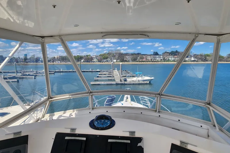 Slide: The Image of View from 1995 Bertram 43 Convertible yacht cockpit overlooking marina and waterfront. - 9