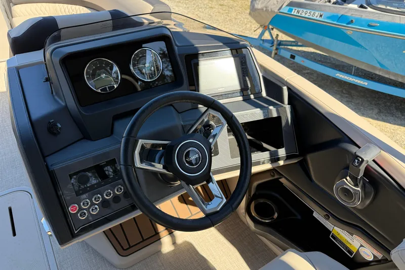 Slide: The Image of 2026 Tahoe Pontoon Cascade Versatile Rear Bench 23 dashboard with steering wheel and controls. - 7