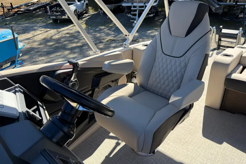 Slide: The Image of 2026 Tahoe Pontoon Cascade Versatile Rear Bench 23 captain's chair and steering wheel. - 9