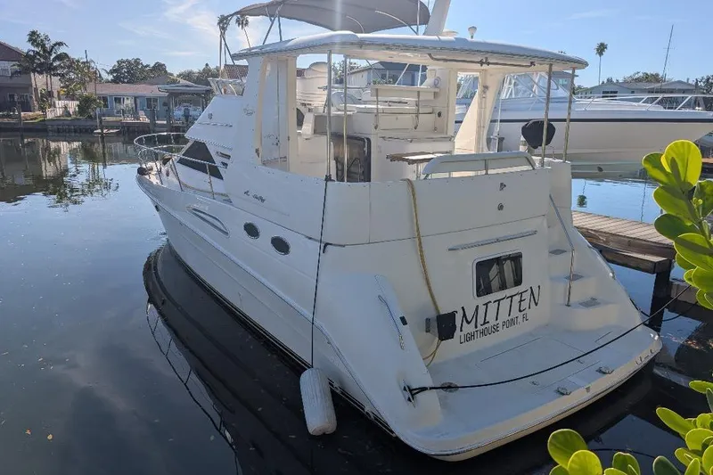 The Image of 2000 Sea Ray 420 Aft Cabin yacht docked in a serene marina setting. - 0