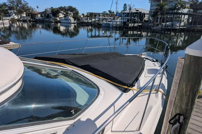 Slide: The Image of 2000 Sea Ray 420 Aft Cabin yacht docked in a serene marina setting. - 5
