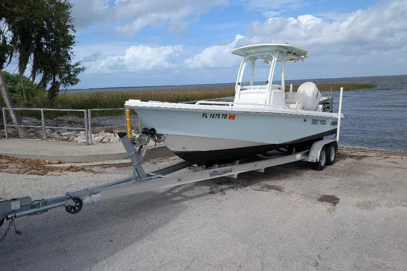 The Image of 2022 Everglades 243 Center Console boat on trailer by the water. - 0