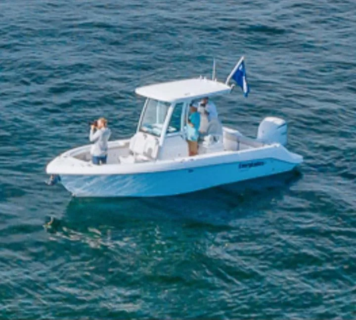 Slide: The Image of 2022 Everglades 243 Center Console boat on open water with passengers. - 3