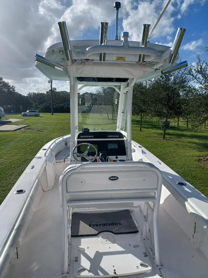 Slide: The Image of 2022 Everglades 243 Center Console boat with T-top, steering console, and rod holders. - 9