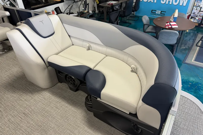 Slide: The Image of 2026 Tahoe Pontoon LTZ Quad Lounger with plush seating at a boat show. - 11