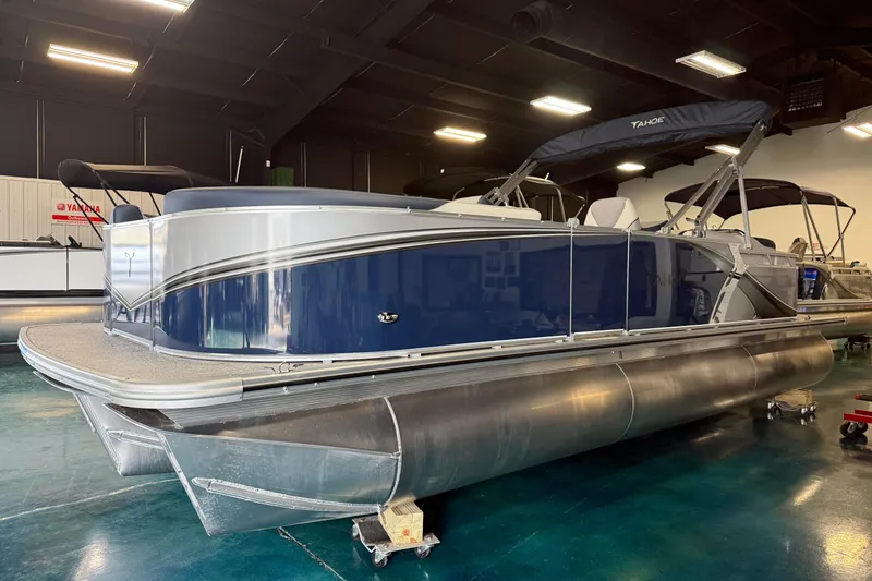 Slide: The Image of 2026 Tahoe Pontoon LTZ Quad Lounger in showroom, featuring sleek design and modern amenities. - 2